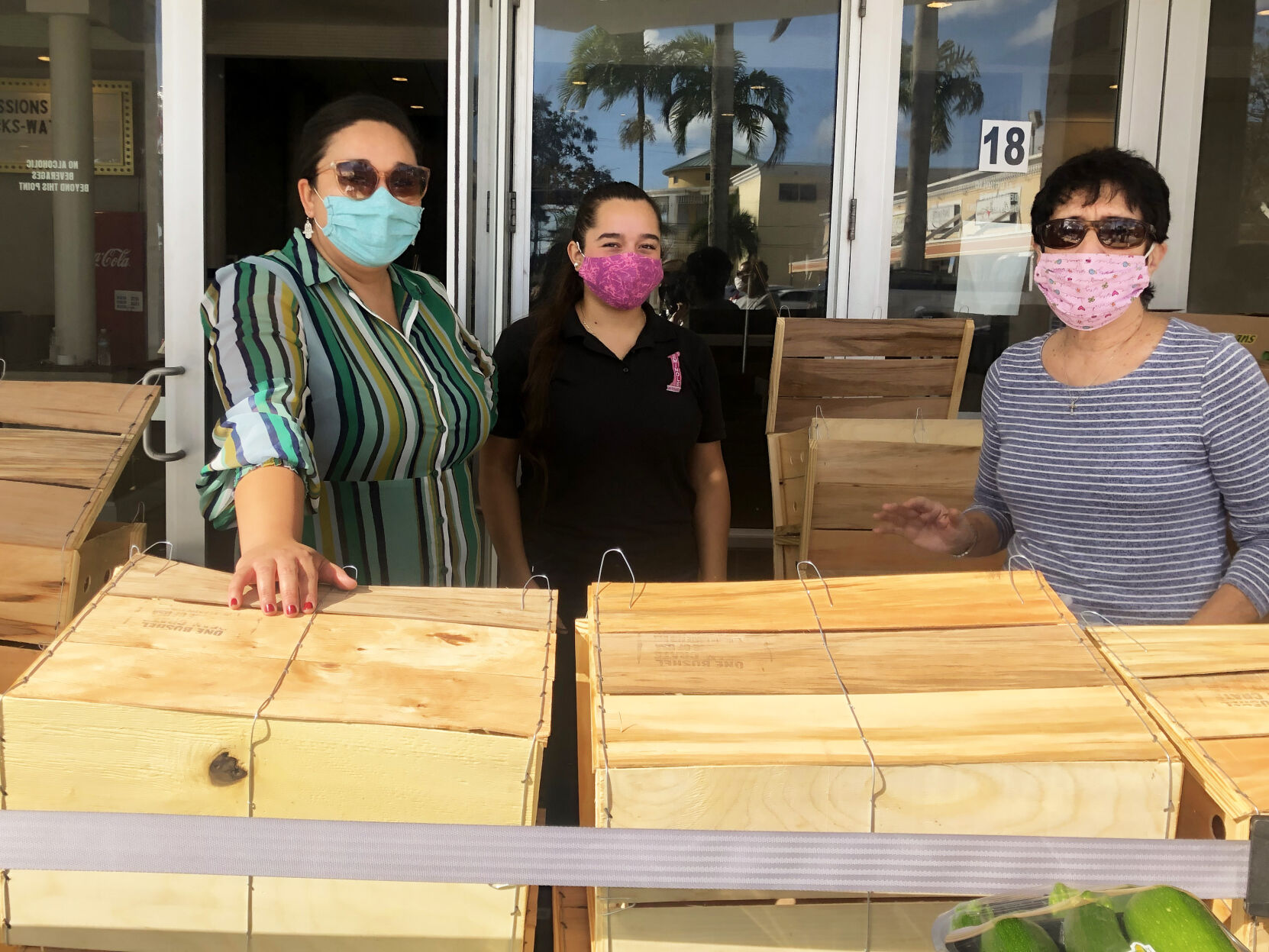 Katherine Rubio and Karina Escalante of the Seminole Theatre were pitching in with Dr. Linda Fagan to prepare 150 baskets for distribution to local families.